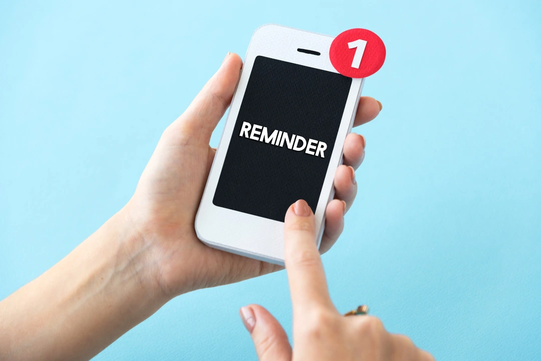 A Reminder notification on a smartphone demonstrates the importance of automation.
