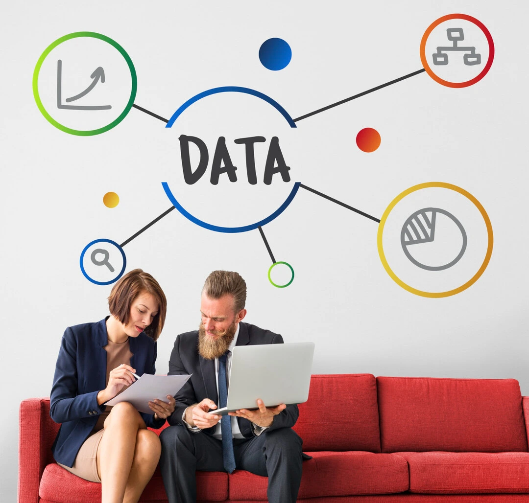 Professionals collaborating with a laptop and documents, highlighting centralized data.