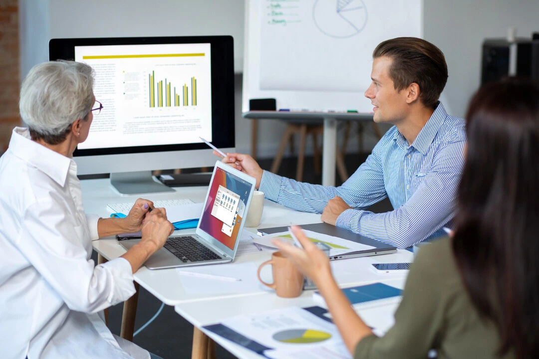 Professionals reviewing rental business data and creating strategies with charts.