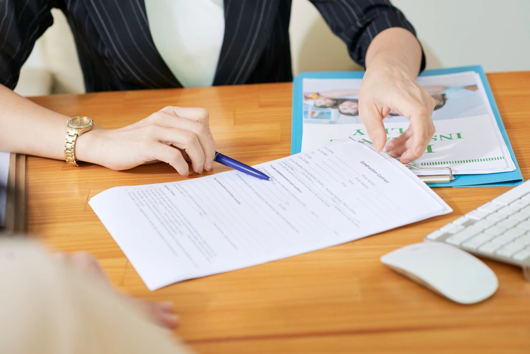 Desk with paperwork illustrating the application process for business licenses.
