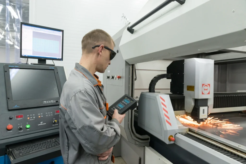 Worker engraving tools with a CNC machine for theft protection.
