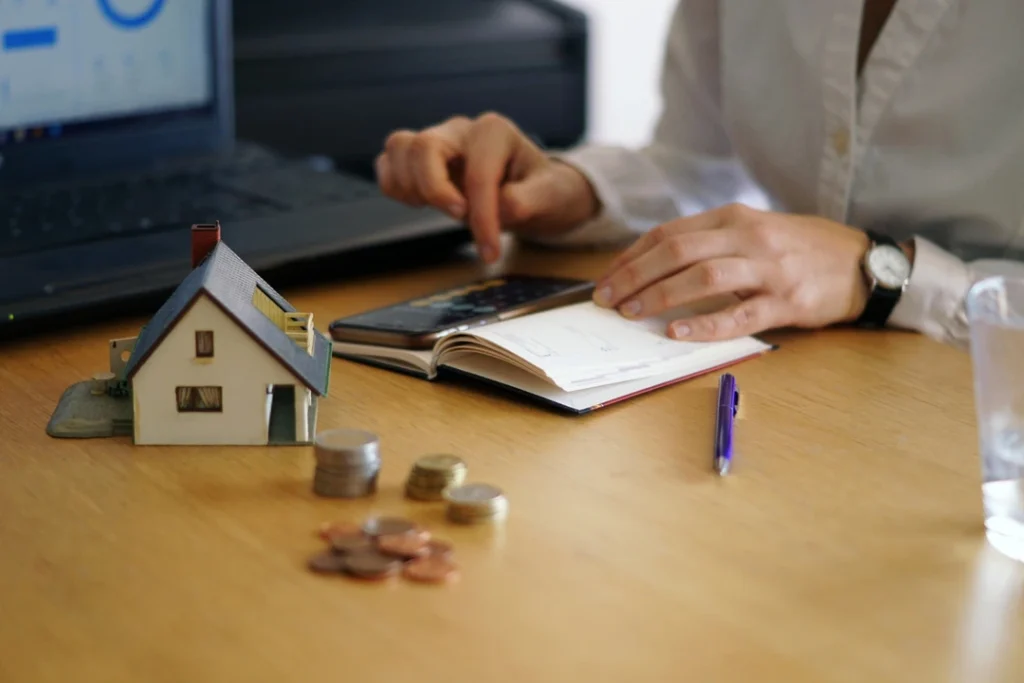 Financial setup with charts and a model house symbolizing short-term rental optimization.