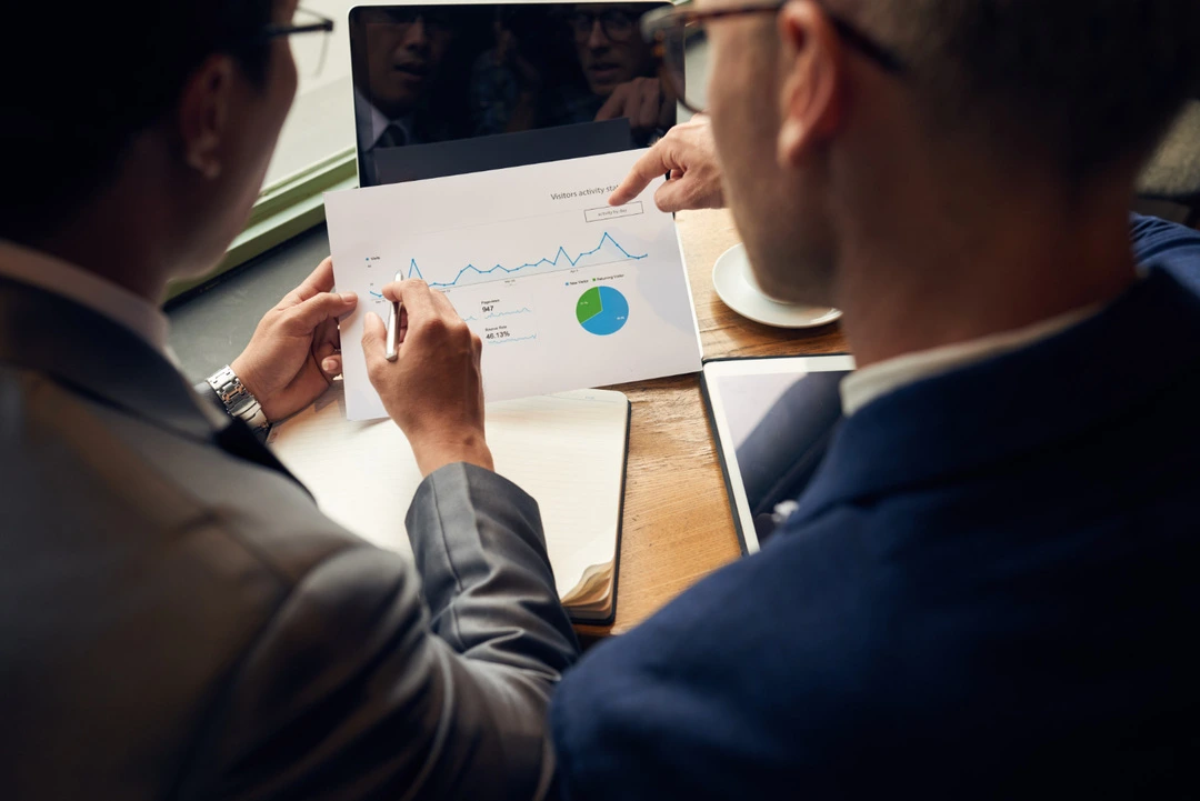 Printed report with graphs and charts being evaluated for market competition insights.