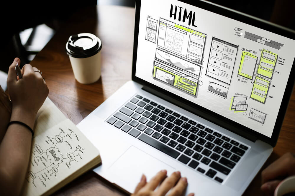 Laptop screen displaying HTML design for a custom online rental website