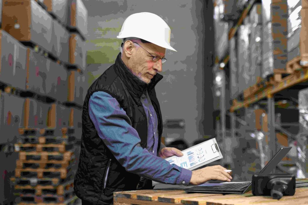 Warehouse worker managing inventory with digital tools for efficient operational strategy