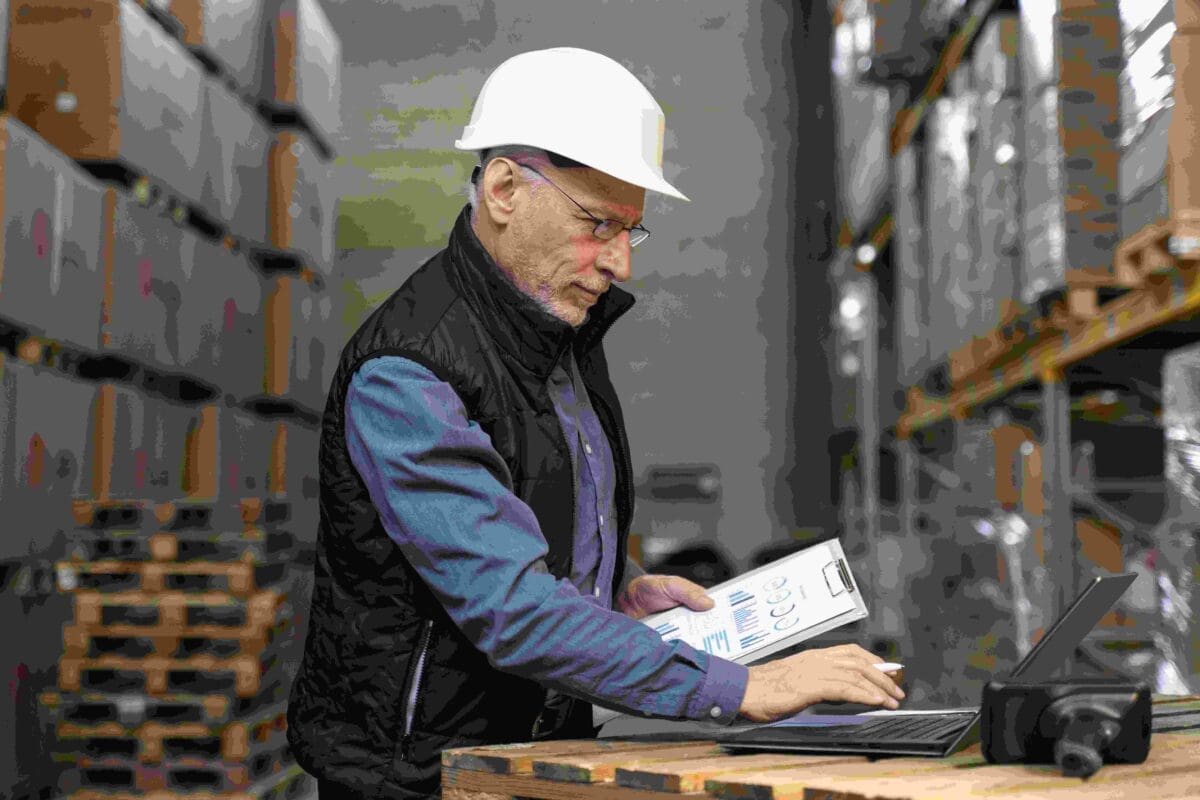 Warehouse worker managing inventory with digital tools for efficient operational strategy