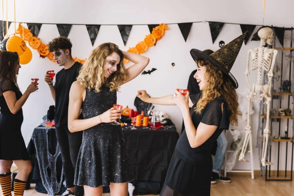 Guests enjoying a Halloween-themed party rental setup with festive decor