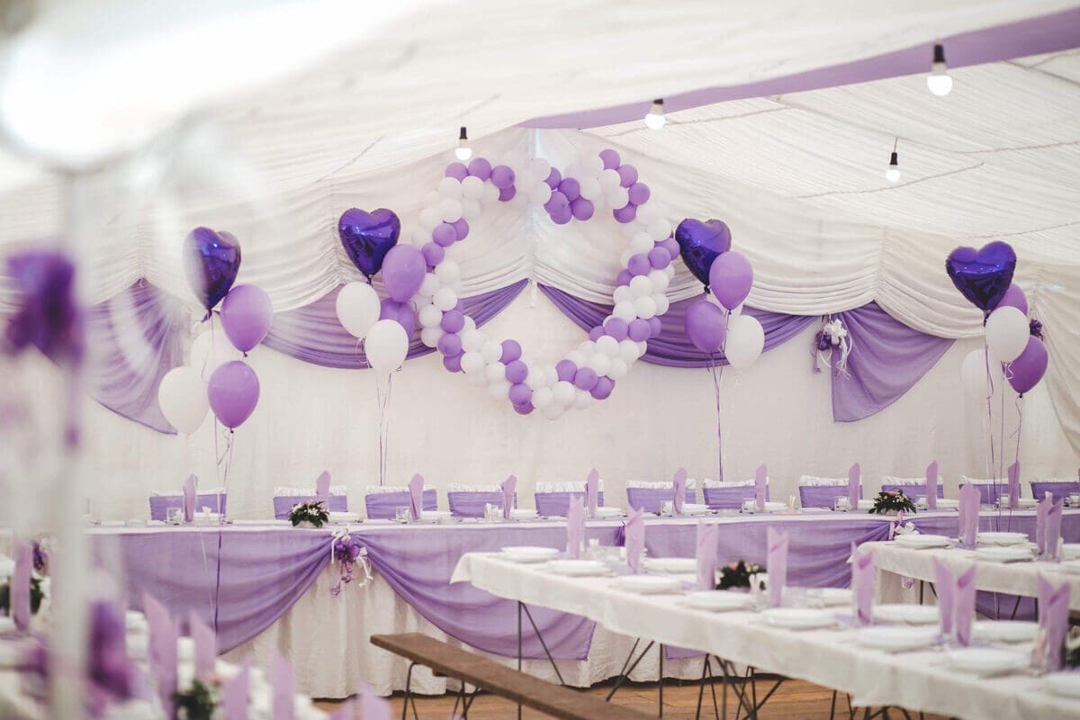 Purple and white party setup with themed decor for trendy party rental ideas