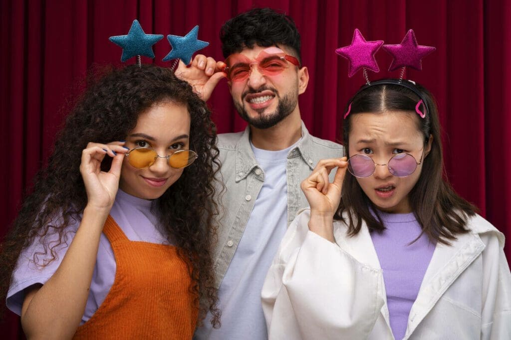 Friends posing with star-themed props in a social media-friendly photo booth rental.