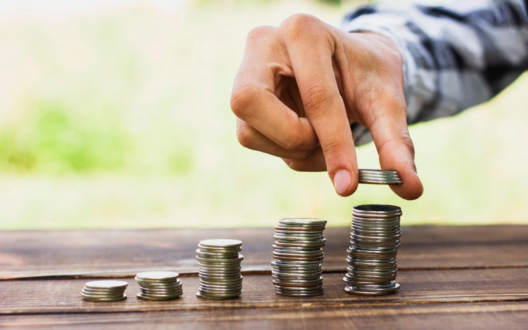 Stacked coins symbolizing thoughtful pricing strategies for a table and chair rental business.