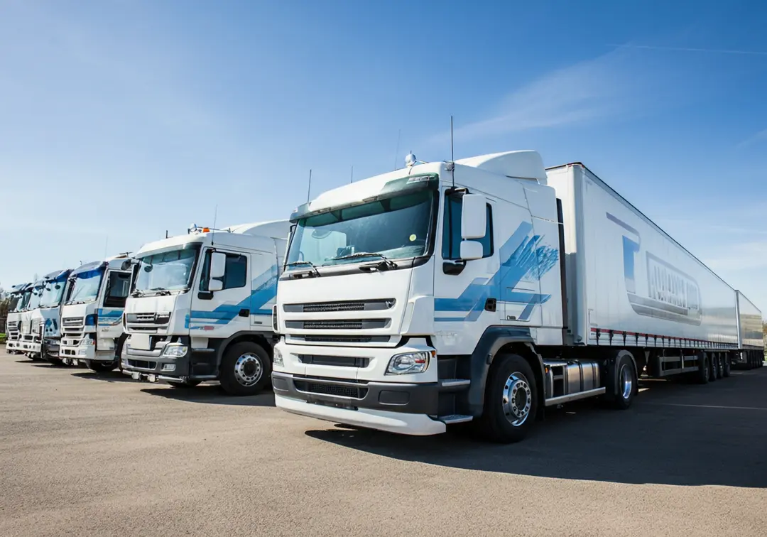 Semi-trailer trucks parked in a yard, emphasizing maintenance for trailer rental fleets.