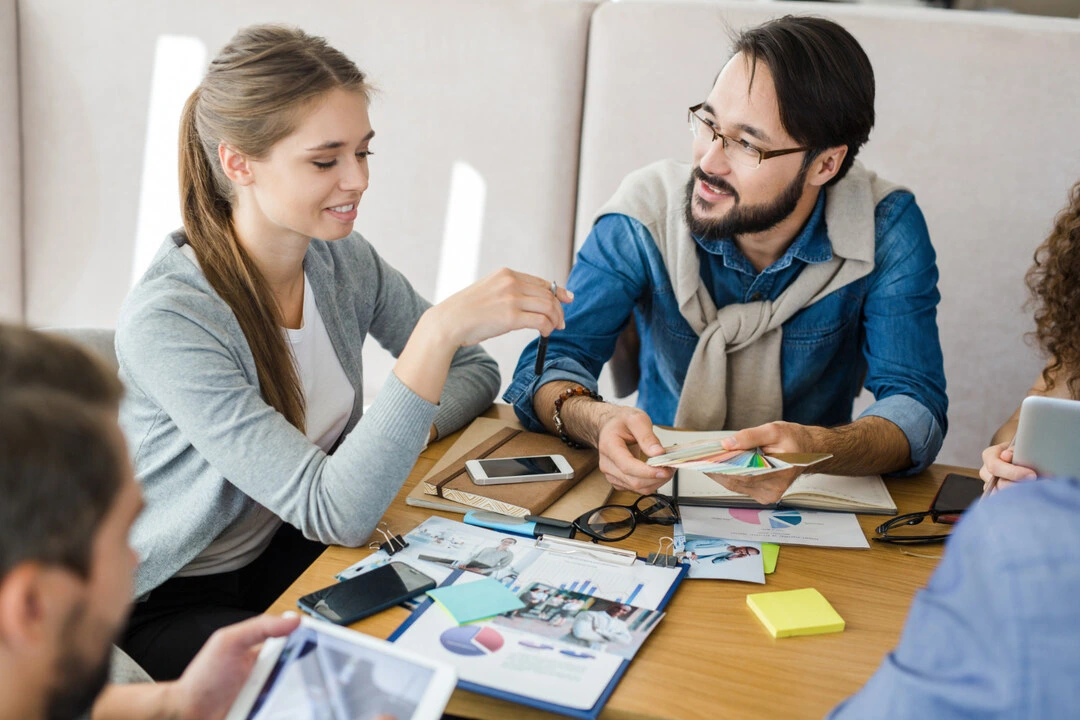 Rental business planning team with charts and strategy.