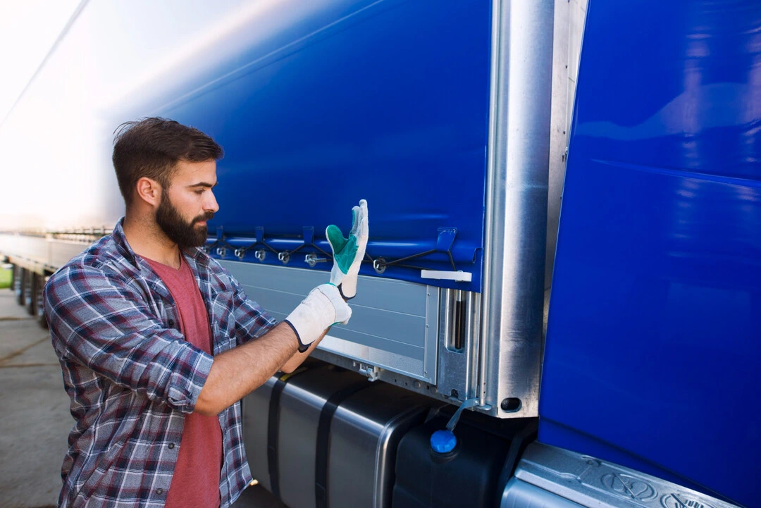 Worker prepping delivery truck for porta potty rental operations