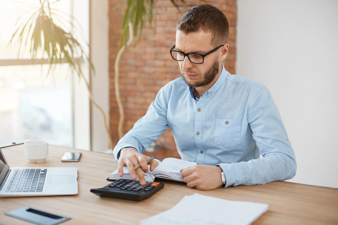 Calculator on a desk, illustrating van rental pricing strategy.