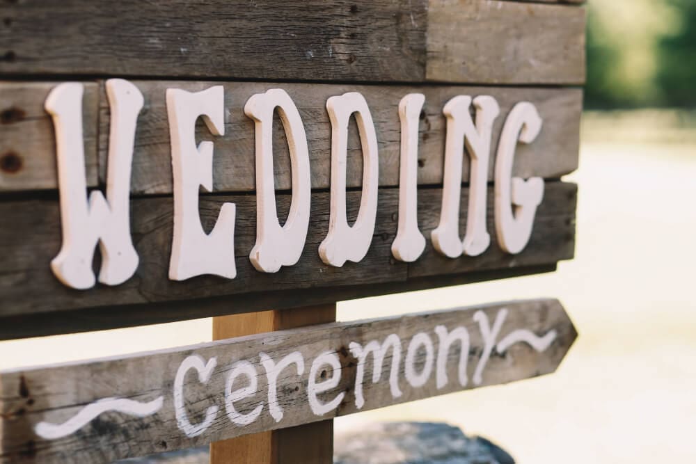 Wooden yard sign for wedding ceremony rental service