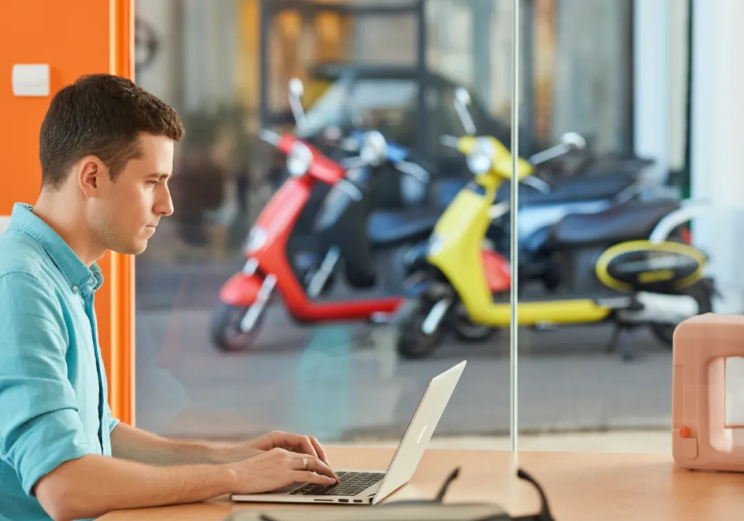 Person managing bookings and logistics for scooter rentals