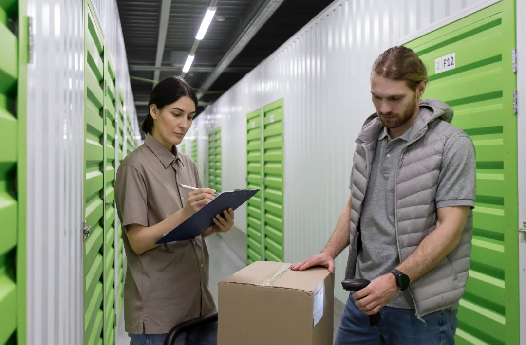 Inventory team scanning and organizing mailboxes in a storage facility.