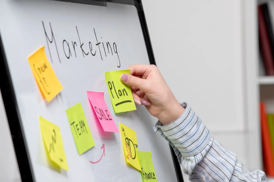 Building a marketing plan with handwritten notes and business tools