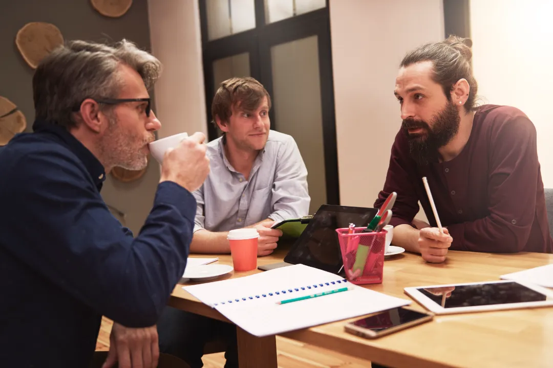 Small business team discussing the best legal structure for a dumpster rental startup