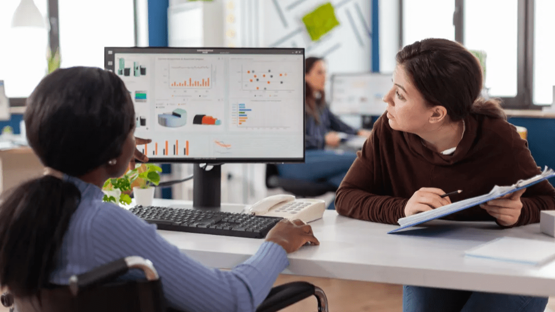 Team members are brainstorming and evaluating visual reports during a business meeting