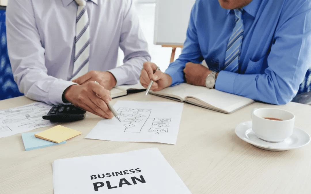 Business meeting focusing on drafting and analyzing a business plan.