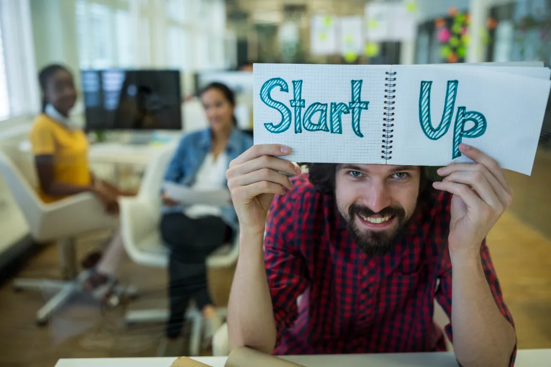Young entrepreneur planning to launch and market a startup rental business in an office setting