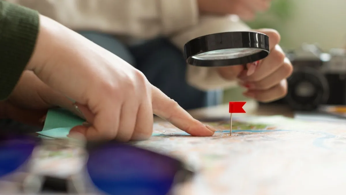Using a magnifying glass and a red flag pin to select an ideal venue location