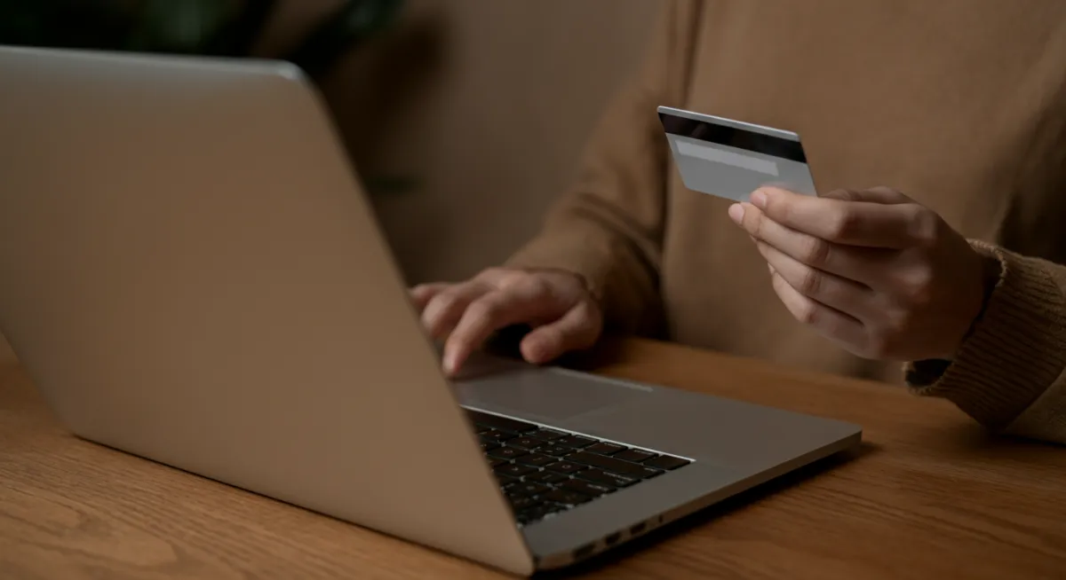 Person booking paddleboard rental online with a card
