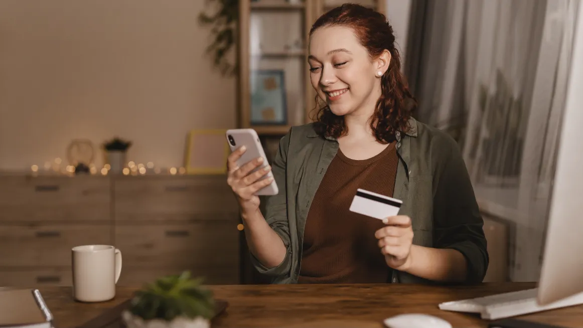 Smiling guest booking a vacation rental on a smartphone