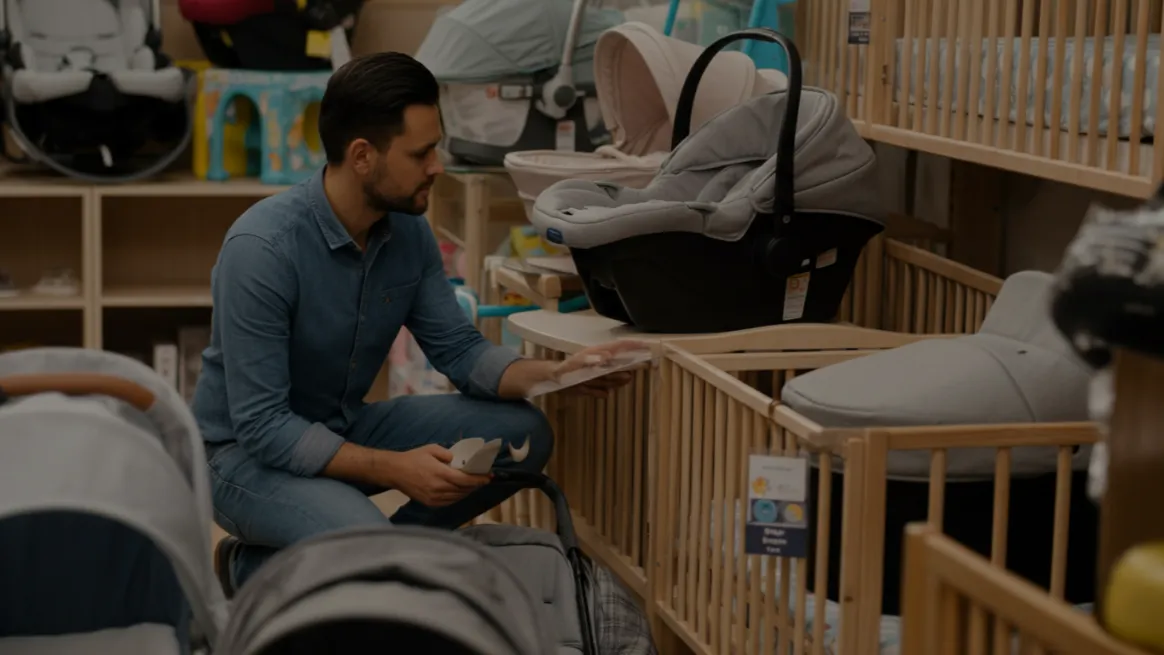 Man sourcing baby gear inventory in a retail setting