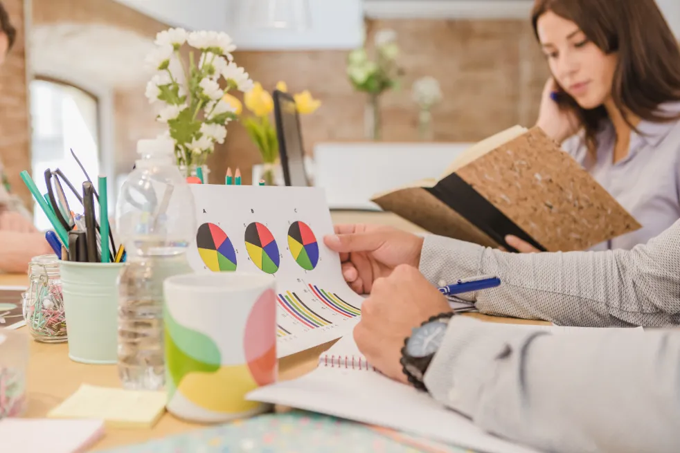 Team analyzing baby gear rental market data with charts and graphs