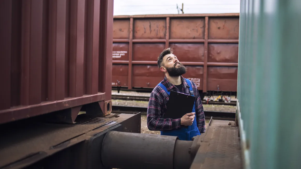 Inspector reviewing freight containers for rental sourcing