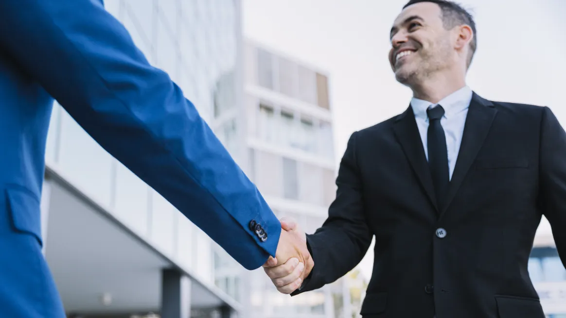 Business professionals sealing a deal to scale container rental operations