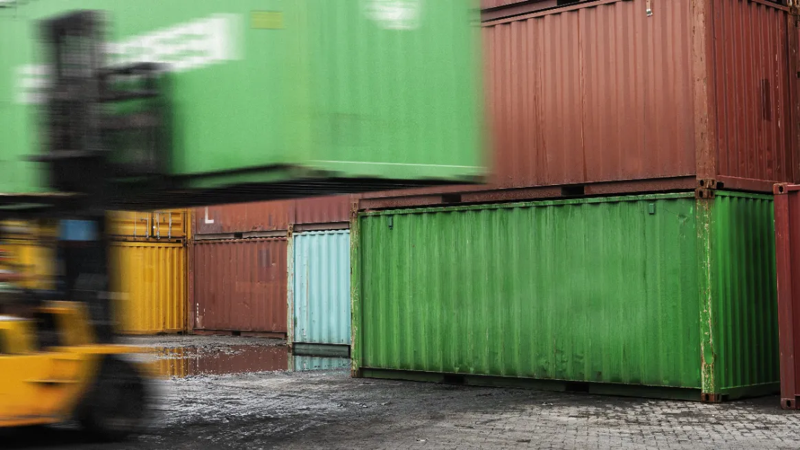 Forklift moving container in rental yard setup