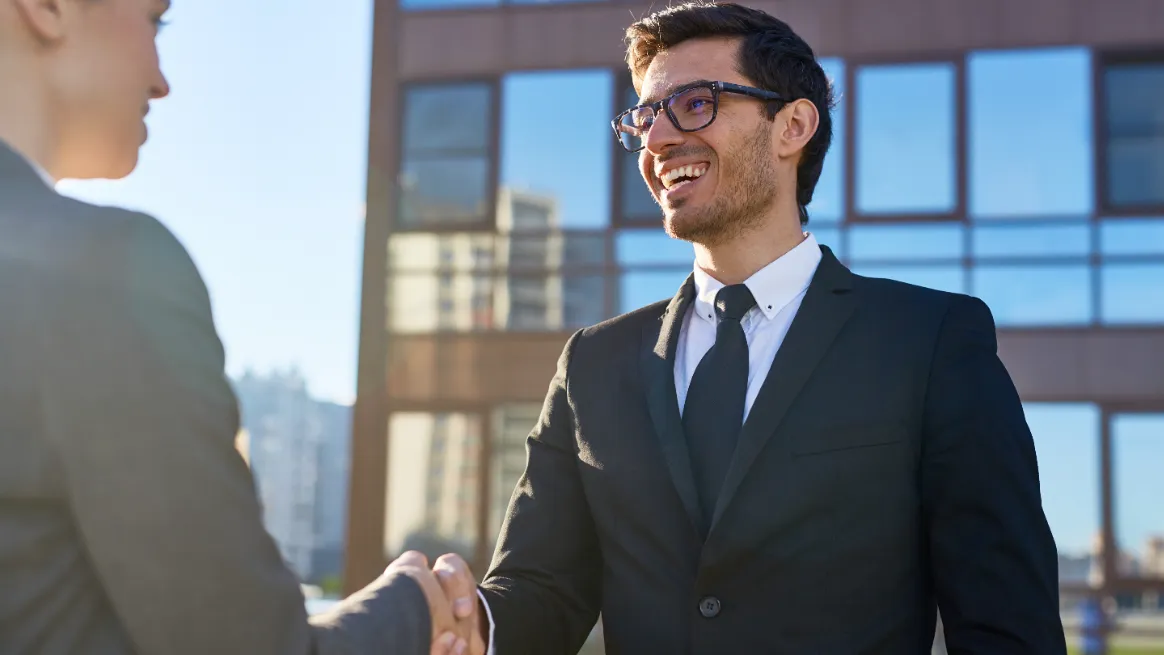 RV rental business partners shaking hands after a successful launch