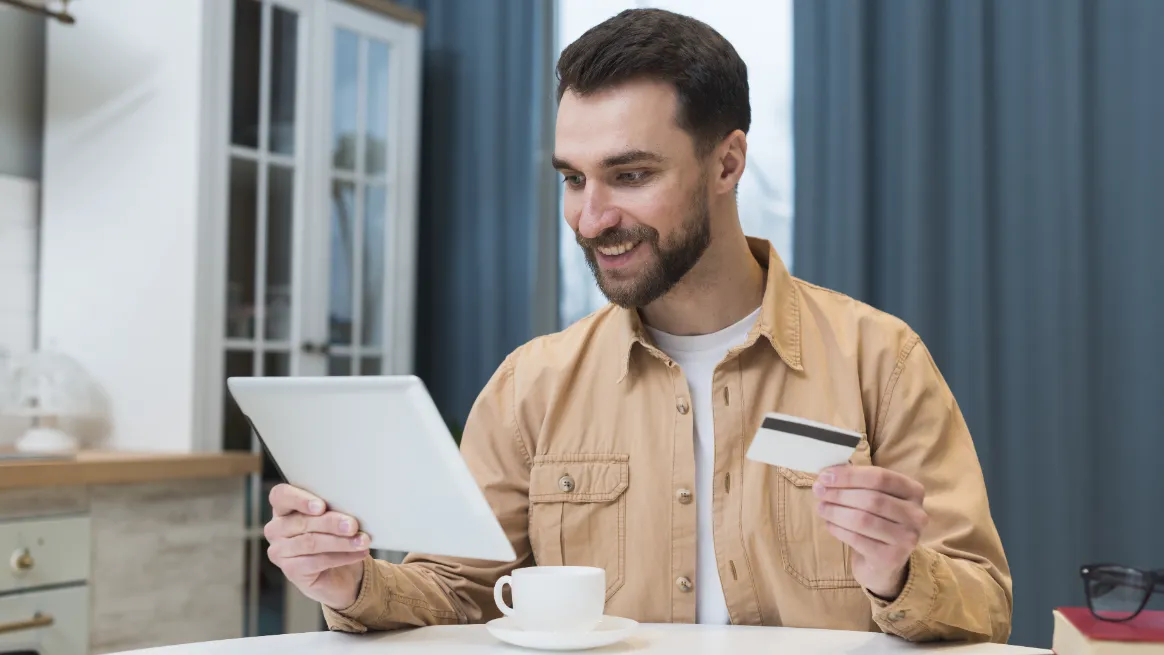 Person using tablet and credit card to reserve RV rental digitally