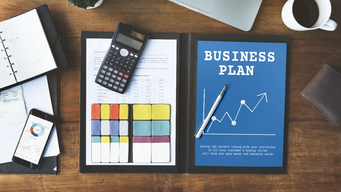 Tent rental funding strategy materials arranged on a wooden desk