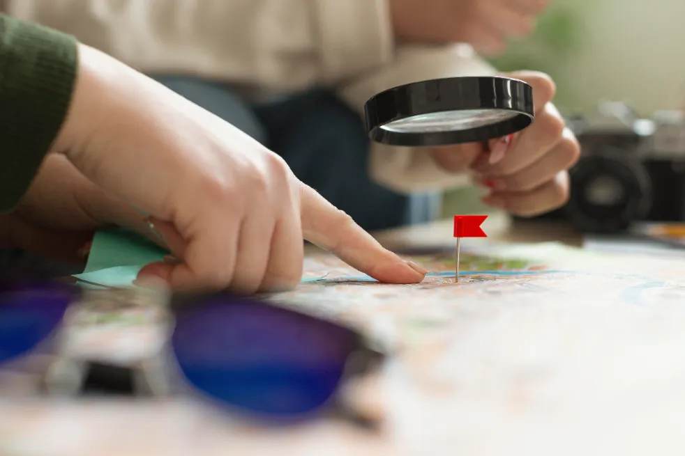 Hands pointing to a map during power bank station location planning