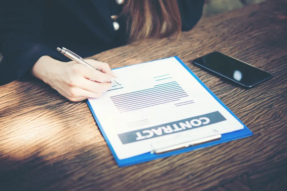 Person signing a contract for a cabin rental business setup